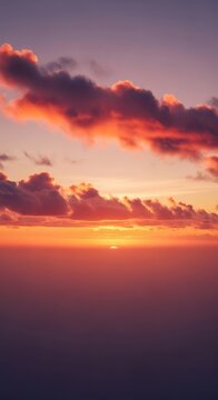 A majestic view of rolling cumulus clouds at sunset, showing vibrant orange and pink hues across a vast, endless horizon of soft light, layers, horizon, airy