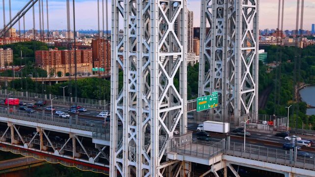 Descend at the metal support of the George Washington Bridge. Watching the hectic traffic on the structure.