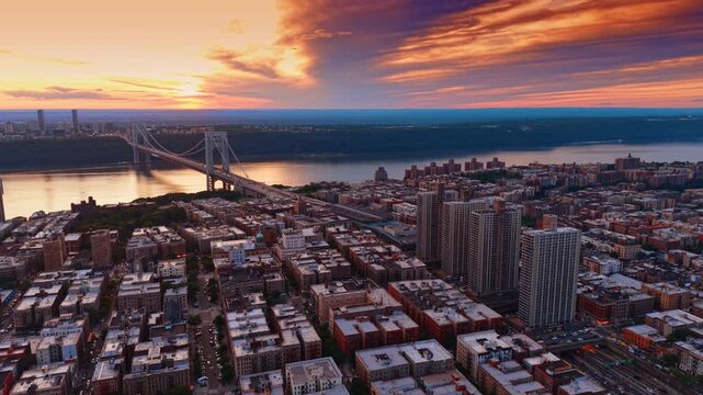 The Washington Heights neighborhood in New York City at sunset. Approaching the George Washington Bridge against colorful sky.