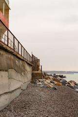 Fototapeta premium Coastal protection structure by the sea. Vertical photo.