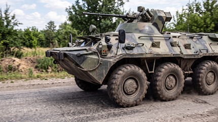 Obraz premium Russian army armored personnel carrier driving on dusty road, military vehicle in desert terrain, armored forces, defense technology and tactical operation concept