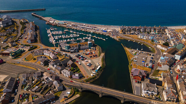 Aerial panorama of Aberystwyth harbor marina boats and stone bridge