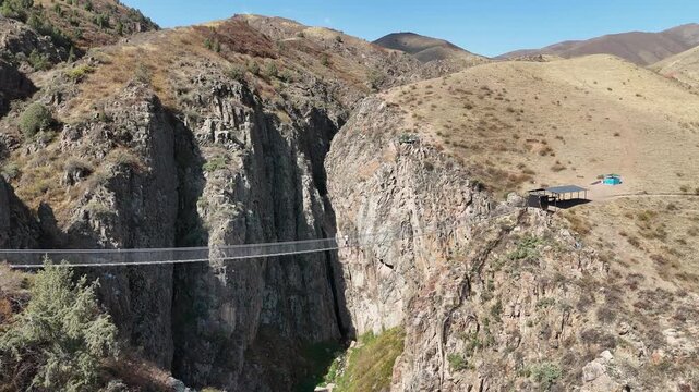 Chunkurchak, Kyrgyzstan December 16, 2025: Iconic Nebesnyy Most Sky Bridge suspended over stunning mountains, offering panoramic views, adventure, and breathtaking landscapes.