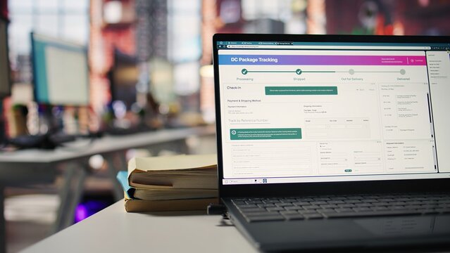 Package tracking software appears on a laptop screen in a call center logistics office, monitoring parcel shipments and searching for items lost in transit during customer service operations.