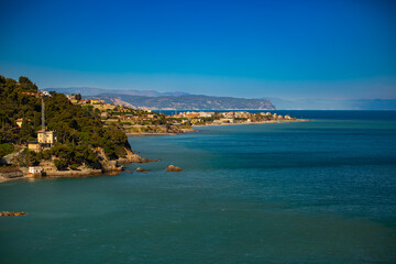 Fototapeta premium Panoramic view of the village on the eastern Ligurian coast. Alassio, Capo Noli, Italy, Liguria, province of Savona. Stunning view of the sea and the village of Alassio with its colorful buildings.