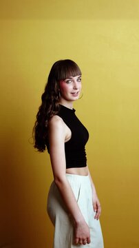 Young woman dancing and winking at camera