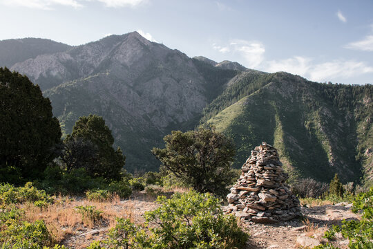 Stacked Rock Cairn Trail Marker on Hidden Valley Loop Trail via Taylor Canyon Above Ogden Utah in Summer with Wasatch Mountain Peaks Beyond