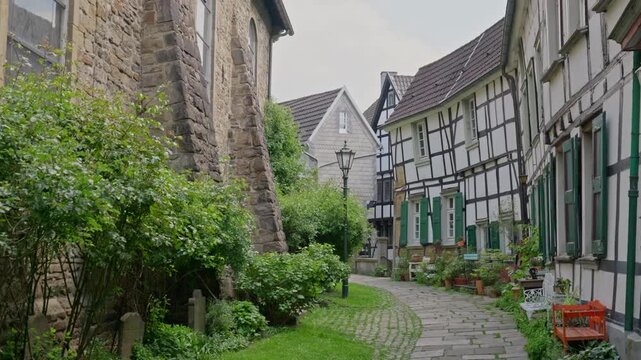 Hattingen Germany old town picturesque cobbled courtyard near historic church with half timbered houses and lantern