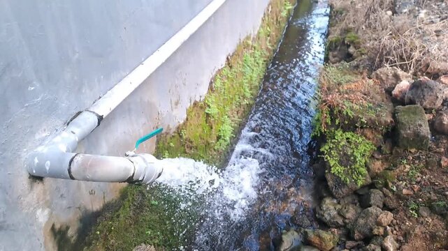 Strong Water Flow from PVC Pipe Drainage, High Pressure Water Discharge in Residential Area, 4K Stock Footage