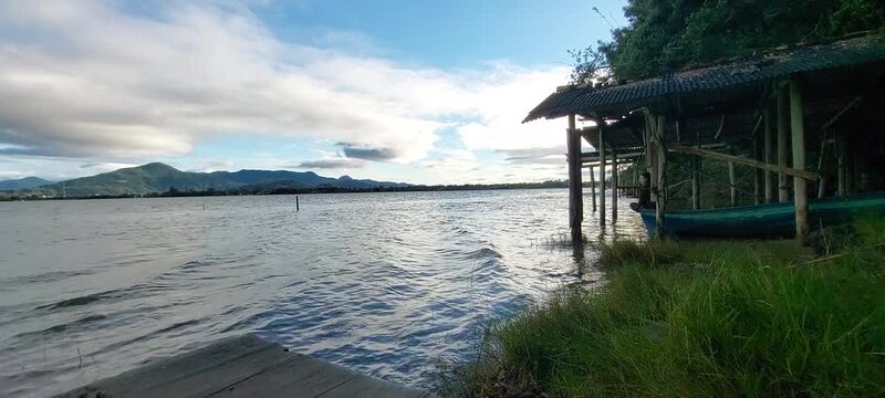 Strong wind and waves at Ibiraquera lake with old boat