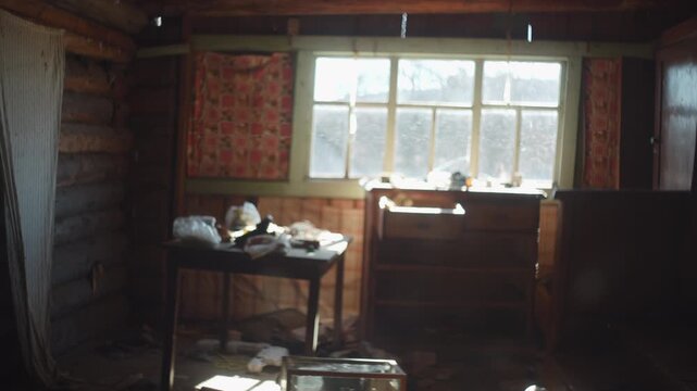 Backlit multi-pane window with dirty mullions inside dim rustic log cabin interior, smudged glass, soft daylight, deep shadows, worn wood, vintage textures, quiet abandoned feeling