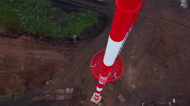 Aerial view of urban construction site with red and white traffic cones, dirt patches, concrete areas, and green vegetation, showing neutral focused layout for development planning