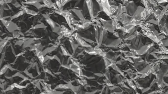A detailed close-up view of a crumpled metallic silver foil surface