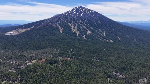 The iconic stratovolcano Mt. Bachelor rises from the Deschutes National Forest in Oregon. This iconic volcanic mountain is part of the Cascade Range and just 22 miles from Bend.