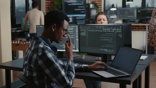 Software developer reviews running code while planning a new user interface, blending brainstorming, software architecture and group problem solving, while discussing source logic.