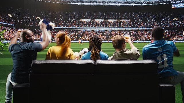Football fans watch a live football match on TV from an apartment sofa, feeling transported to a stadium field by lifelike experiential broadcasting.