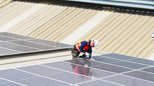 Professional installer placing solar panels on rooftop to promote clean energy and environmental sustainability