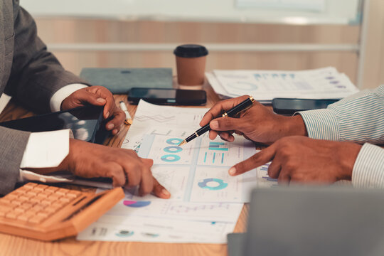 Business team presenting financial charts and marketing data during a meeting in the office.Keywords