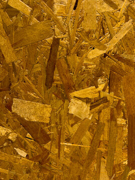 Close up of oriented strand board wood texture featuring engineered timber surface for construction and design backgrounds