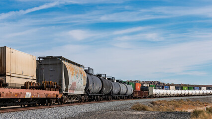 A long Union Pacific Railroad freight train featuring weathered covered hopper cars and tank cars. © hit1912