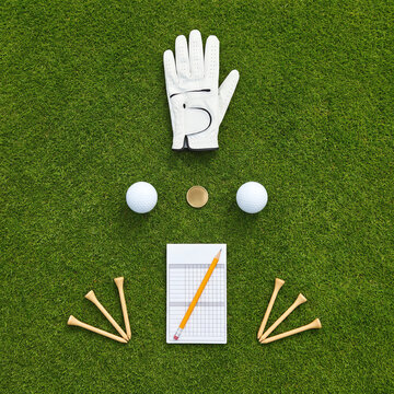 Golf Essentials Flat Lay on Green Grass &ndash; Glove, Balls, Scorecard, Tees Overhead View