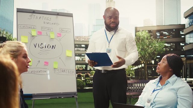 Businessman leading presentation and pointing at board in meeting for metrics and business planning and with strategy notes business planning.