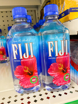 Close up of two Fiji natural artesian water bottles featuring a red hibiscus on the label
