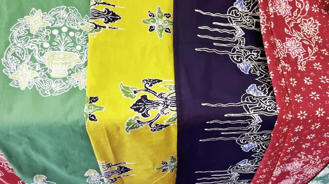 Close-up video of traditional Indonesian batik fabric with intricate floral and ornamental patterns. Ideal for culture  textile  craftsmanship  heritage  fashion  and design themes.