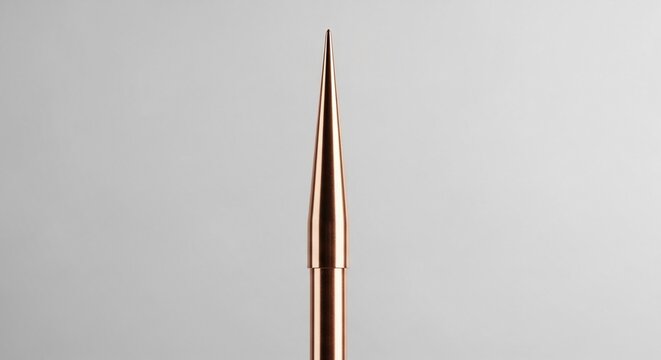 A gleaming copper lightning rod with a sharp point, an essential electrical protection device isolated on a neutral background