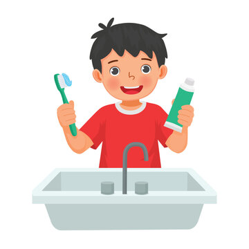 Little boy brushing teeth holding toothbrush and toothpaste 