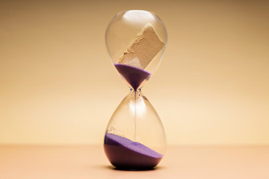 Hourglass with torn paper message, storytelling, unfinished memories