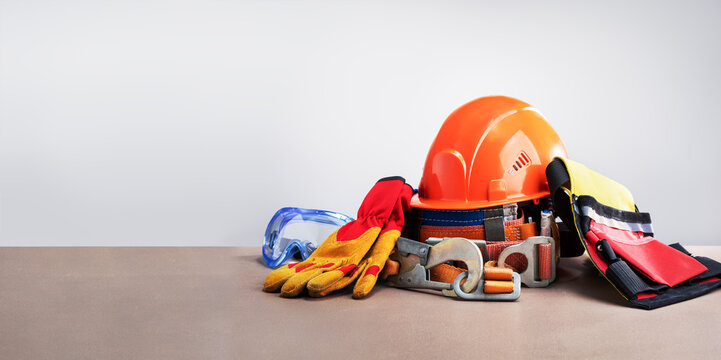 composition with safety equipment on light grey background. banner with copy space.