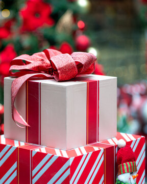 Box Christmas presents wrapped and tied with red ribbon.
