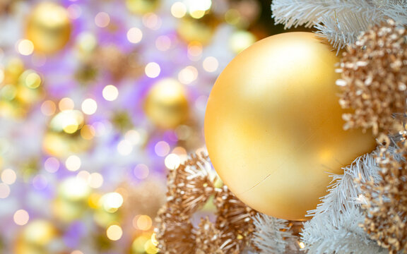 Golden ball with lovely light bokeh on the background.