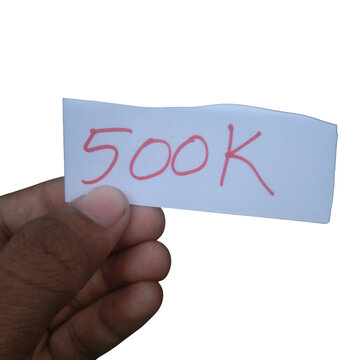Hand holding a paper note with 500k written on it isolated on transparent background