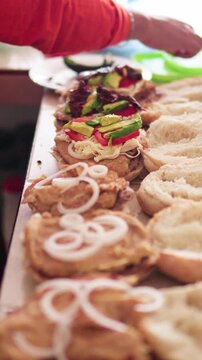 Mexican street food vendor preparing traditional cemita sandwiches