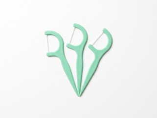 Naklejka premium Mint Green Dental Floss Picks on White Background