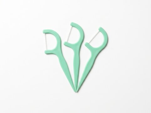 Mint Green Dental Floss Picks on White Background