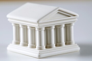 Obraz premium Miniature white neoclassical building with columns, representing architecture, law, or finance