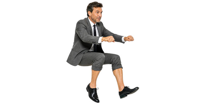 Successful Businessman Miming Driving an Invisible Car with Focused Expression Isolated