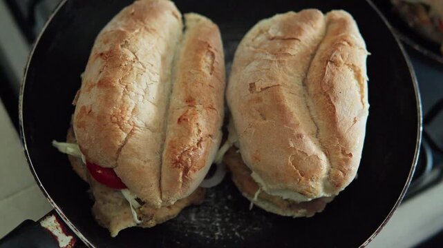 Traditional mexican tortas sandwiches cooking in pan