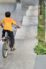 Obraz premium little boy riding a bike