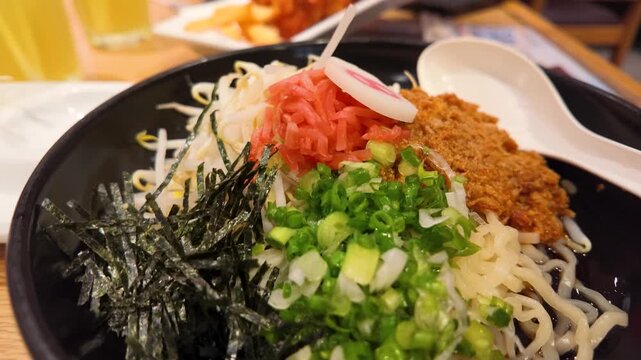 Japanese Ramen Bowl with Scallions and Ginger in Black Ceramic Bowl