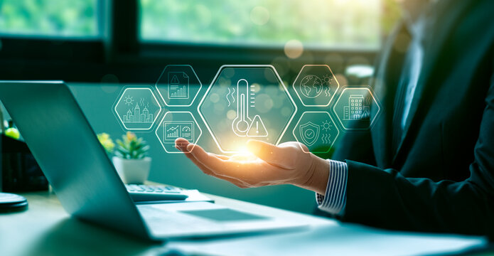 Climate risk management concept with business professional holding virtual heat warning interface showing global warming impact urban safety environmental monitoring and sustainability planning