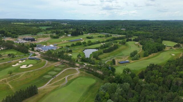 Stunning aerial drone footage captures TPC Toronto At Osprey Valley in Ontario set for the RBC Canadian Open, showcasing manicured fairways, lush greens, event setup in natural daylight.