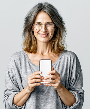 Senior Woman Showing Smartphone Mockup &ndash; Generative AI &ndash; no real persons