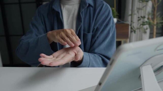 Asian man learning to using sign language