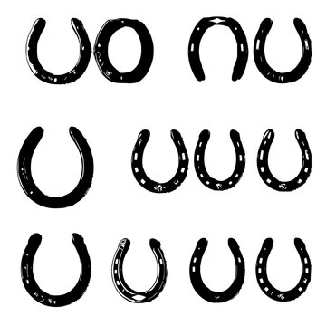 Collection of twelve distinct horseshoes arranged in a grid of three rows and four columns, each with unique decorative patterns and designs, set against a plain white background. The horseshoes ar...