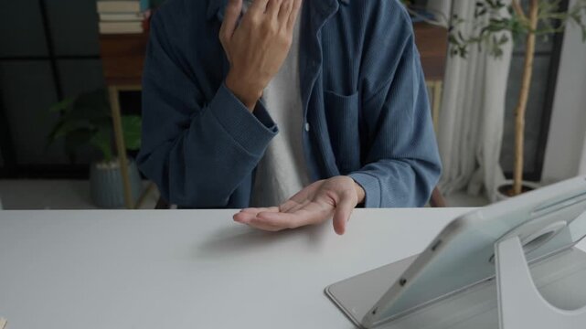 Asian man learning to using sign language