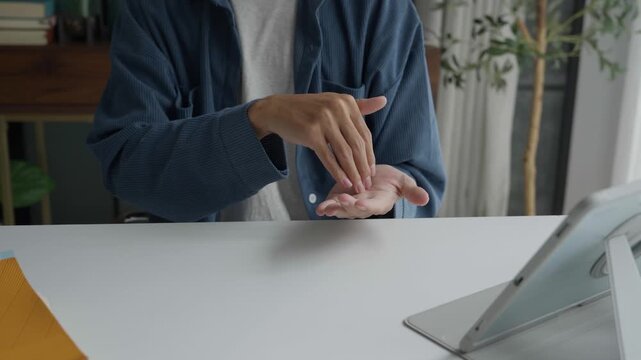 Asian man learning to using sign language